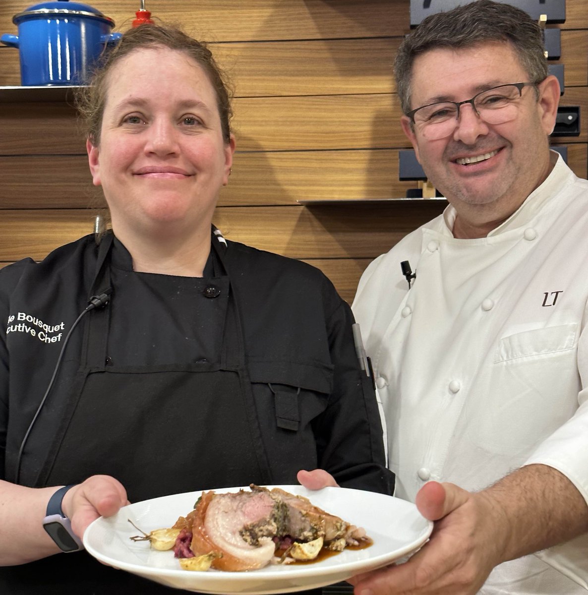 Star chef Laurent Tourondel and L’Amico exec chef Emilie Bousquet Walsh present their Porchetta Alla Romana with braised red cabbage, farro, Tuscan kale, and quince mostarda — a dish demonstrated at De Gustibus Cooking School on the last day of the fall 2022 season.