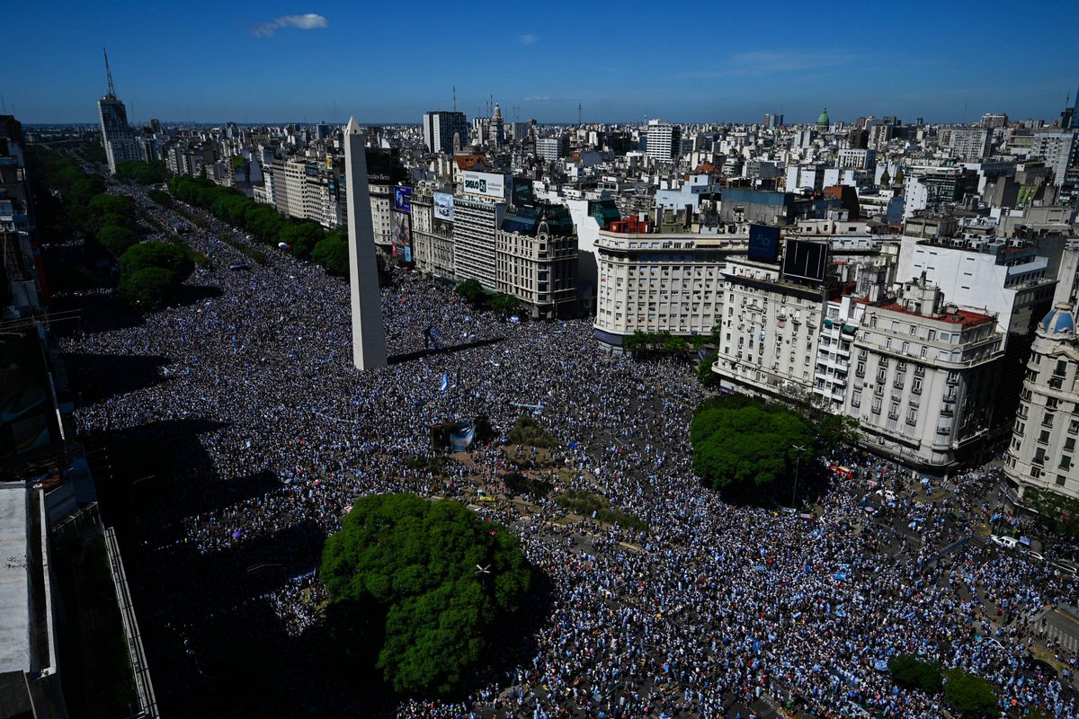 JacobsBen's tweet photo. Some fans haven't left their spot since Argentina won the World Cup on Sunday. Incredible and beautiful scenes in Buenos Aires as Argentina parade their World Cup trophy.🏆🇦🇷 https://t.co/Z3sFR2G7sp