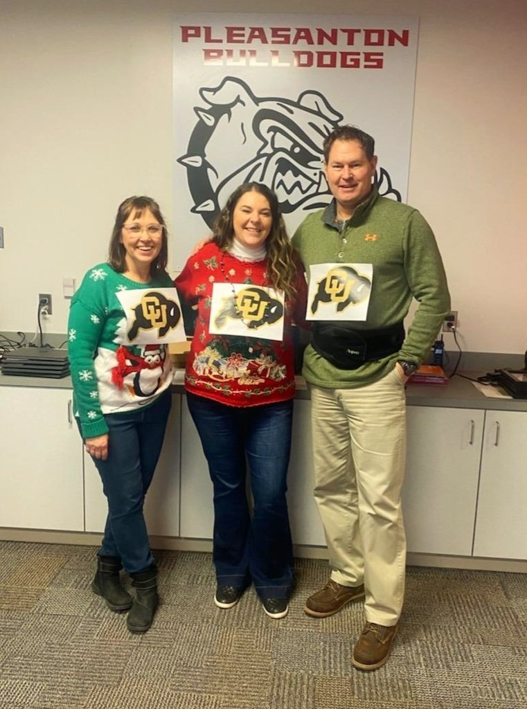 BulldogsPHS's tweet photo. The office staff showed off their "Ugly Christmas Sweaters" to Mr. Lightle this afternoon! Poor guy is a Colorado Buffaloes fan. We are trying to get him to see the light. GO BIG RED!!! https://t.co/O451AWNQCq