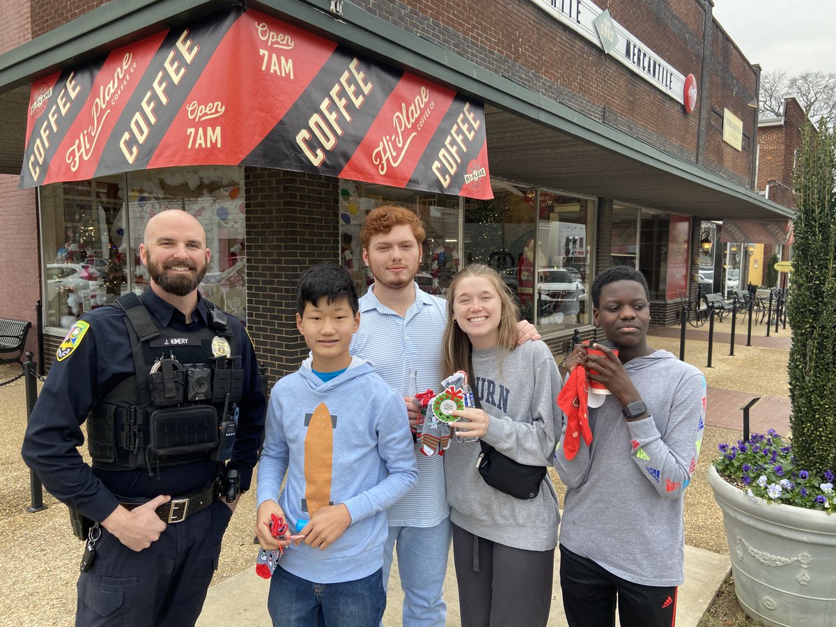 AthensAL's tweet photo. Shoppers in Downtown received a police-issued Christmas challenge: do a good deed. The family of Levi Hays, a local student who died in August, gave APD a bag of socks. Each had a candy cane & good deed challenge that said #LiveLikeLevi. Officer Kimery issued the challenges today https://t.co/OygwXtY7J4