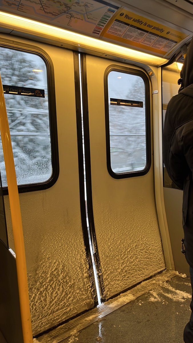 Alexandur's tweet photo. @TransLink many of this model of sky train (mark III?) are having this exact same door issue in this heavy snow ice condition where it thinks it’s closed or maybe knows it’s not closed but it stops with this same exact gap on many different sky trains but all of the same mark. https://t.co/4i9xdpvL4S