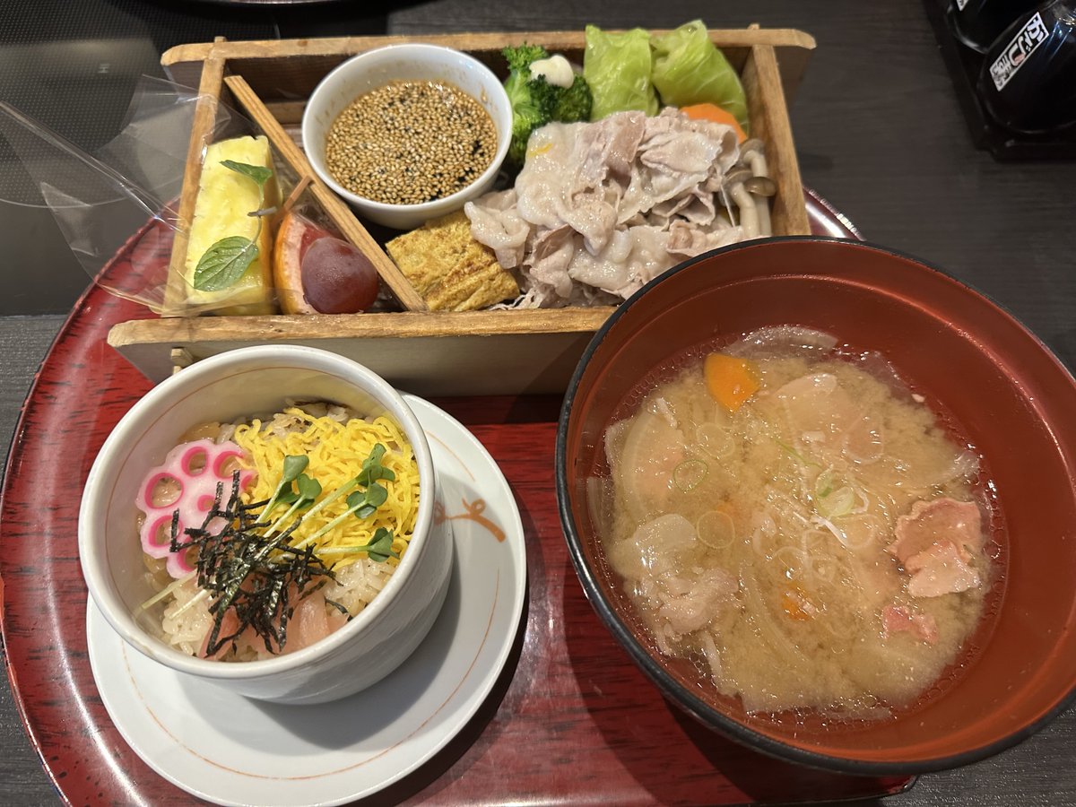 Japanese styled healthy lunch, some boiled pork and vegetables and dip source with sesames, miso soup (right hand), sushi rice b