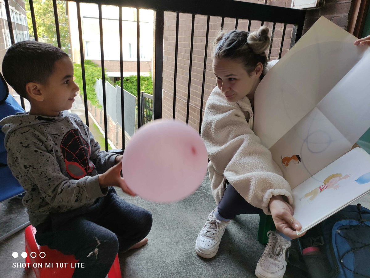DoorstepLib's tweet photo. One of the sweetest moments we've had this year! Our Camden #volunteer Simona reading The Blue Balloon by #MickInkpen with one of the children we visit. He was so excited to read it with his own pink balloon! https://t.co/6g3jOvZ8s0