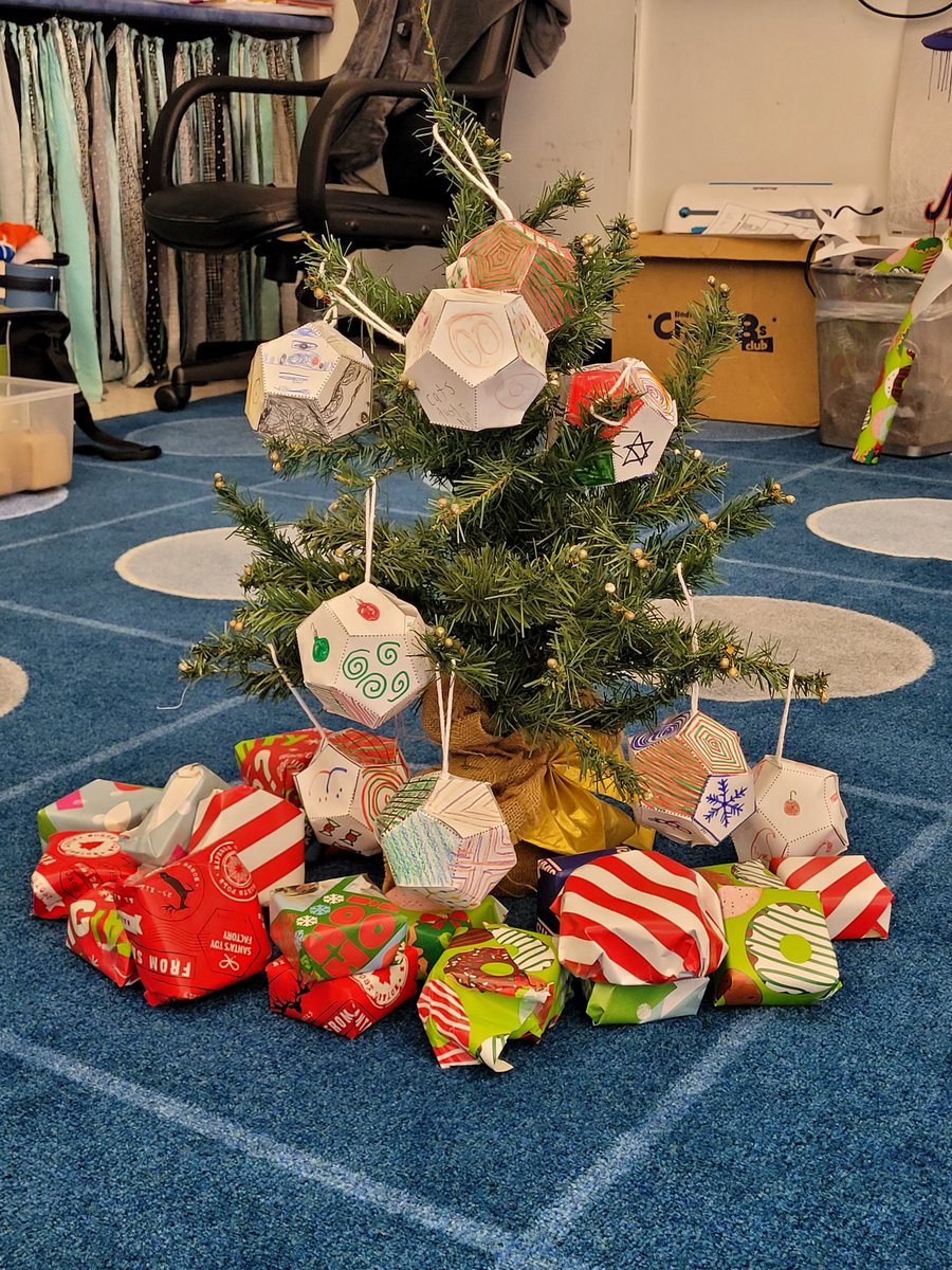 MrsCgrade5's tweet photo. @OceanAveSchool 5th used a math formula to wrap presents to reduce paper &amp; tape waste. Then we placed them under our dodecahedron ornaments! #mtpspride #oaspride https://t.co/alL9xqSIvp