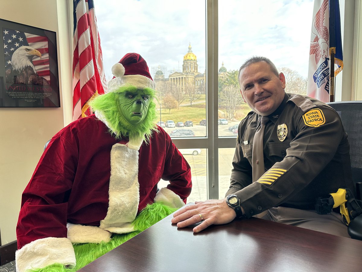 iowastatepatrol's tweet photo. Tis the season - Sergeant Dinkla spotted the Grinch not wearing his seatbelt. Off to Colonel Fulk’s office for a little talk and an arm wrestling contest! https://t.co/z8eMPhQrq1