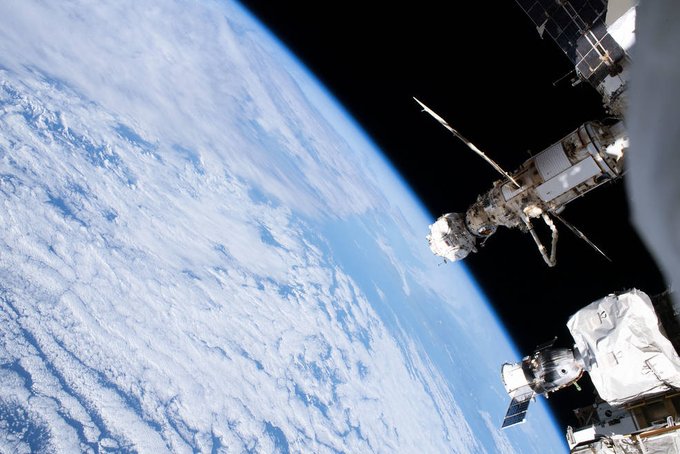 The Nauka multipurpose laboratory module, the Prichal docking module, and the Soyuz MS-22 crew ship are seen on the right of this image, their white exteriors in sharp contrast to the darkness of space. Earth, mostly covered with white clouds, dominates the rest of the photo. Credit: NASA