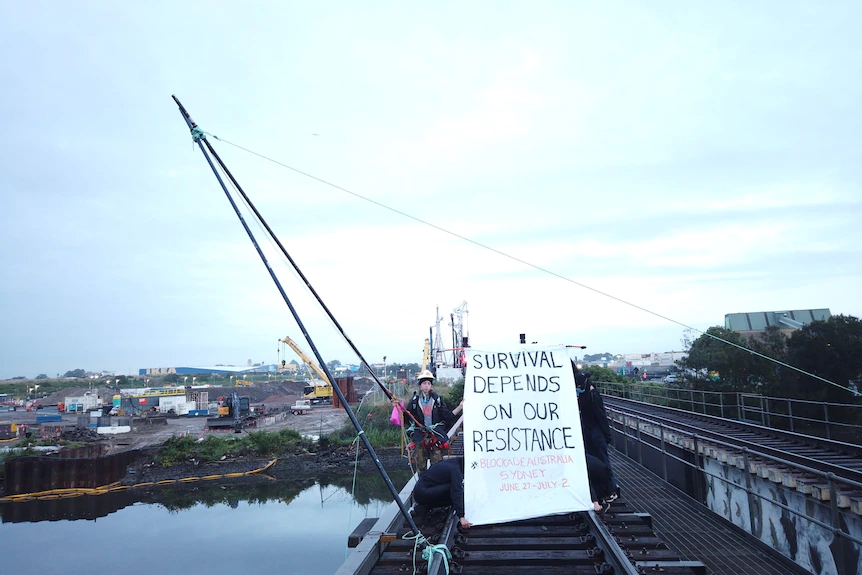 SeanPolitics27's tweet photo. Blockade Australia climate activist handed 'rap on knuckles' over Port Botany protest. A climate activist who held up Port Botany's freight line for three hours has been handed a one-year community sentence. https://t.co/H4V7ZcCseE