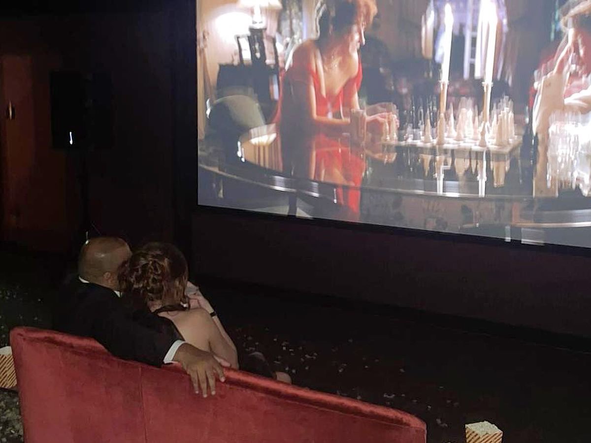 CarlyStarrs's tweet photo. Thought S &amp; I were going to dinner and instead I walked into the theatre at Cameron House that he had rented out + filled with all my loved ones for my 30th where we all watched my favourite film🥺 Polaroids hanging from balloons, a saxophone player and the most amazing cake 😭♥️ https://t.co/NvC7EHhgYq