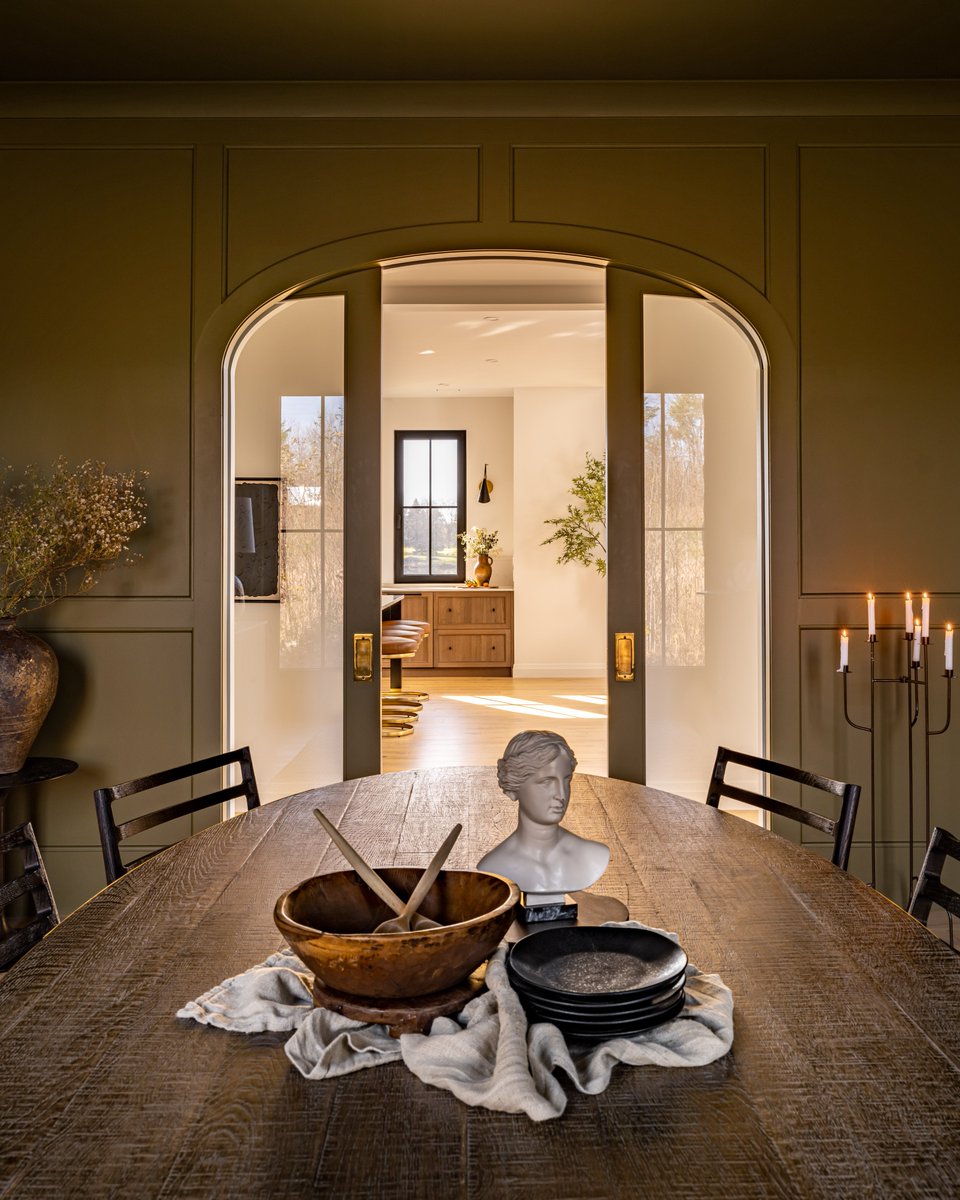 We'd like a dinner party invite please! 🤤
We painted walls and ceiling in Benjamin Moore's beautiful 2143-10 “Sage” &amp; wainscotting was added for European charm.
And the showstopper of this space? The custom 3-point arched glass doors of course. 🖤
#ProjectNewHouseOldCharm