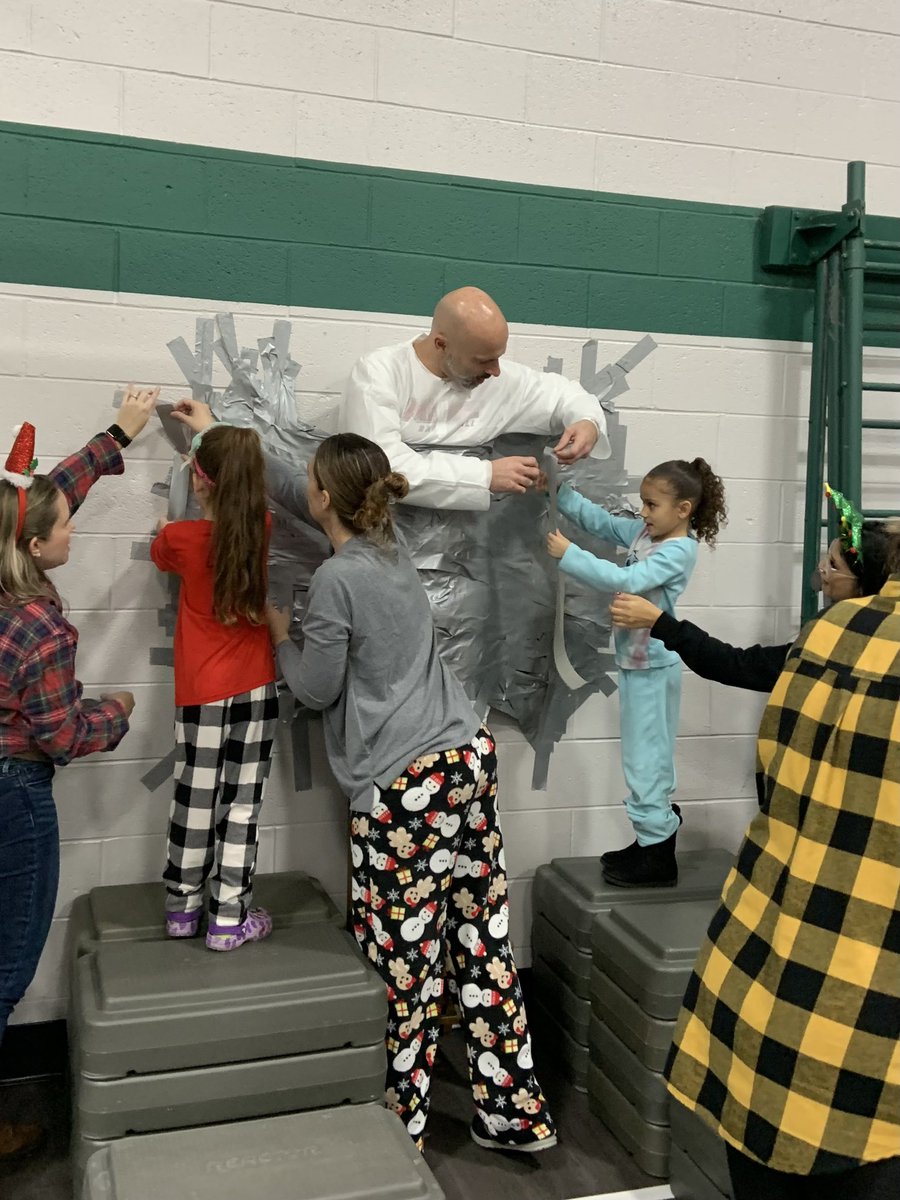 JenMirdala's tweet photo. We went on an elf hunt and taped Mr. Chiera to the wall…what a way to start our winter break! See everyone in 2️⃣0️⃣2️⃣3️⃣!🎉⛄️@IAES18Chiera https://t.co/POGzU6jbxb