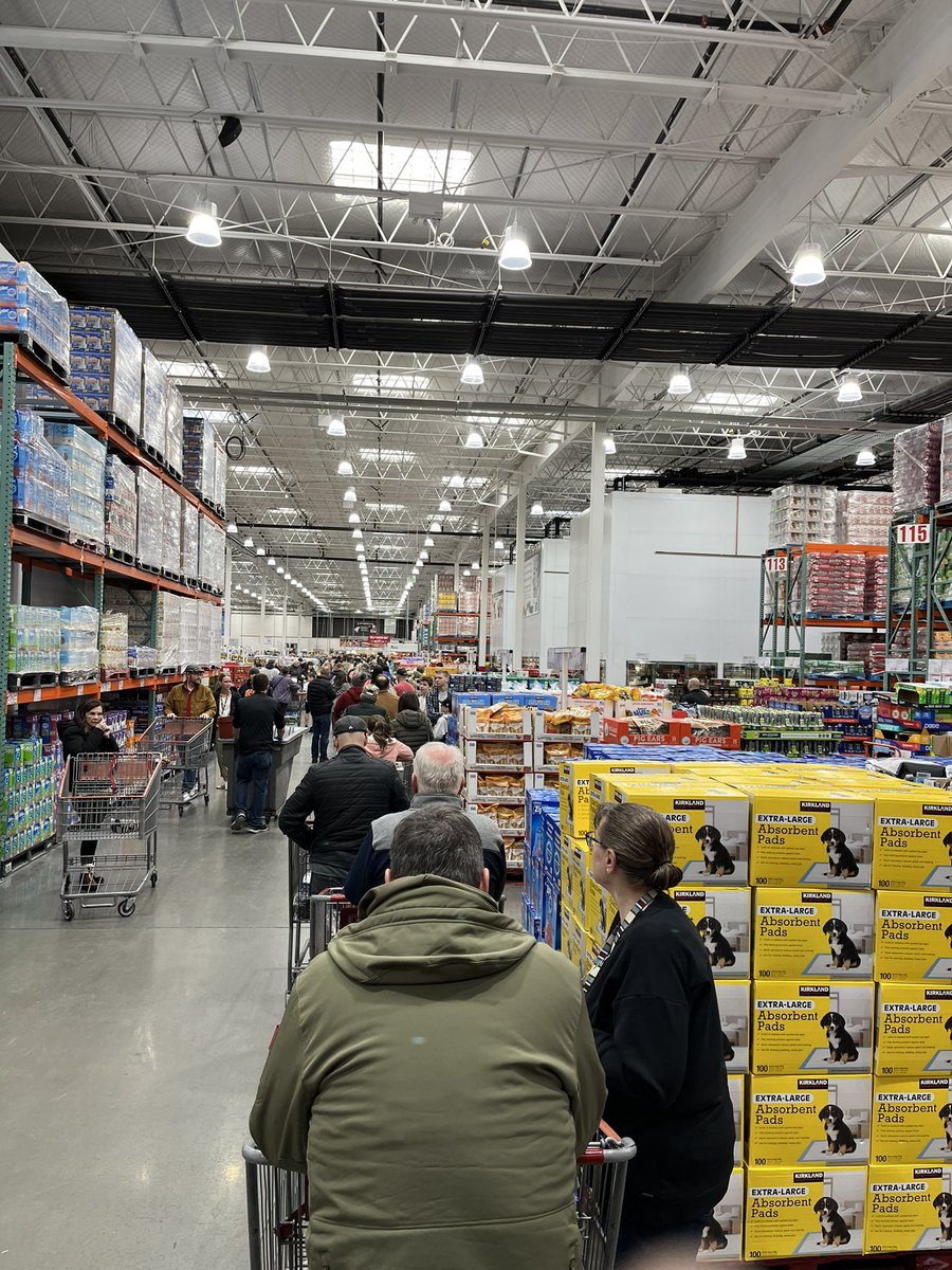 SpencerJCox's tweet photo. So traumatic—I almost hesitate to share it—but I’m proud of all of us who survived the Great Costco Line of 12/23. At some point this morning Costco’s network failed and the line went to the back of the store and around the corner past the toilet paper.  But we are resilient.😂 https://t.co/fq7pg5ObIQ