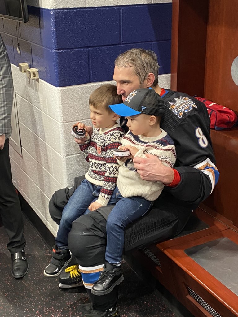 Alex Ovechkin with his two sons, Sergei and Ilya, holding pucks 801 and 802.