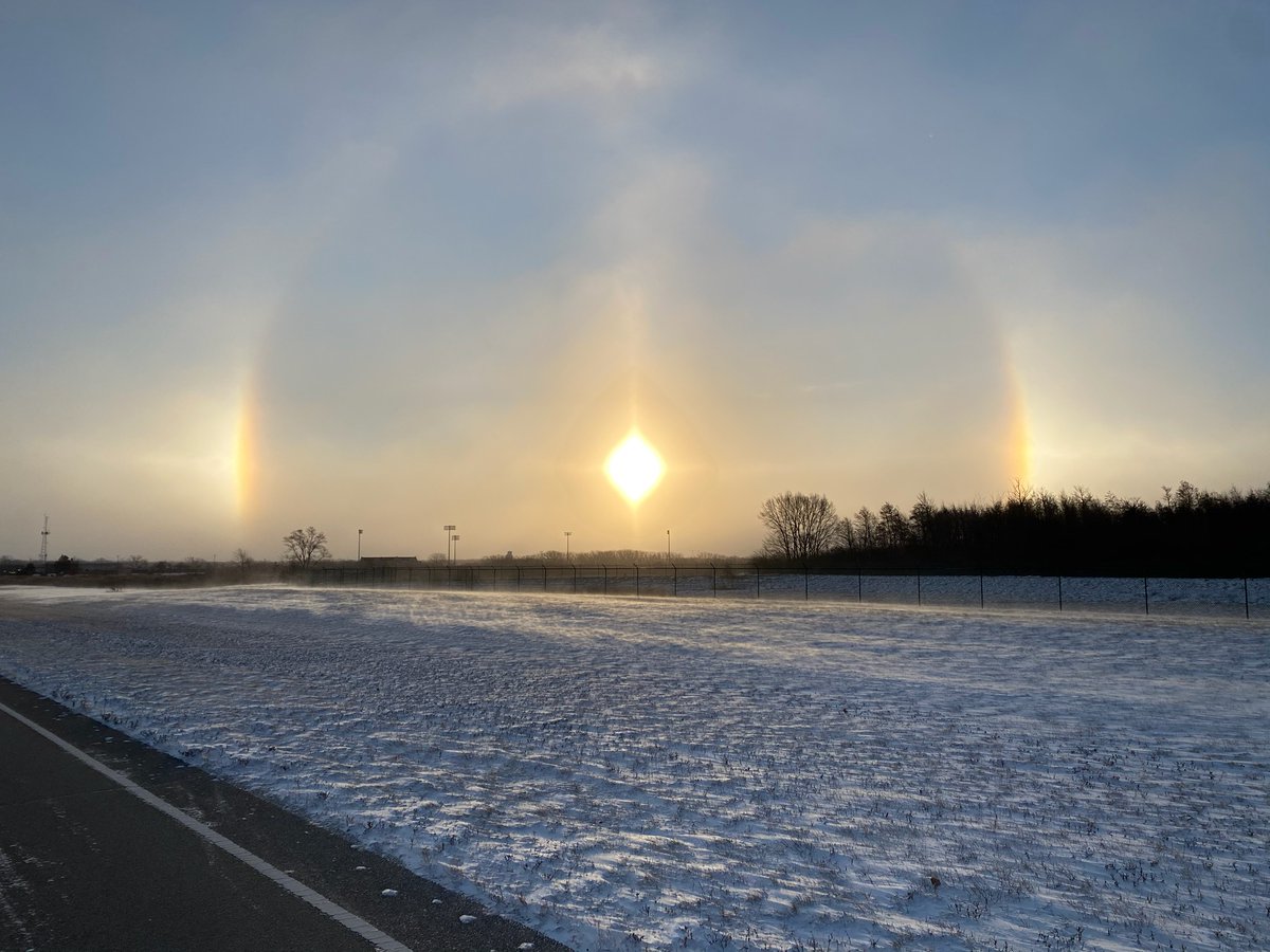 NWSChicago's tweet photo. Did you see the sundogs this morning? The phenomena is caused by sunlight going through suspended ice crystals. They're common during arctic airmasses, as is the case this morning. Here's a shot taken outside our office this morning! #ilwx #inwx https://t.co/fEE0WupzzK