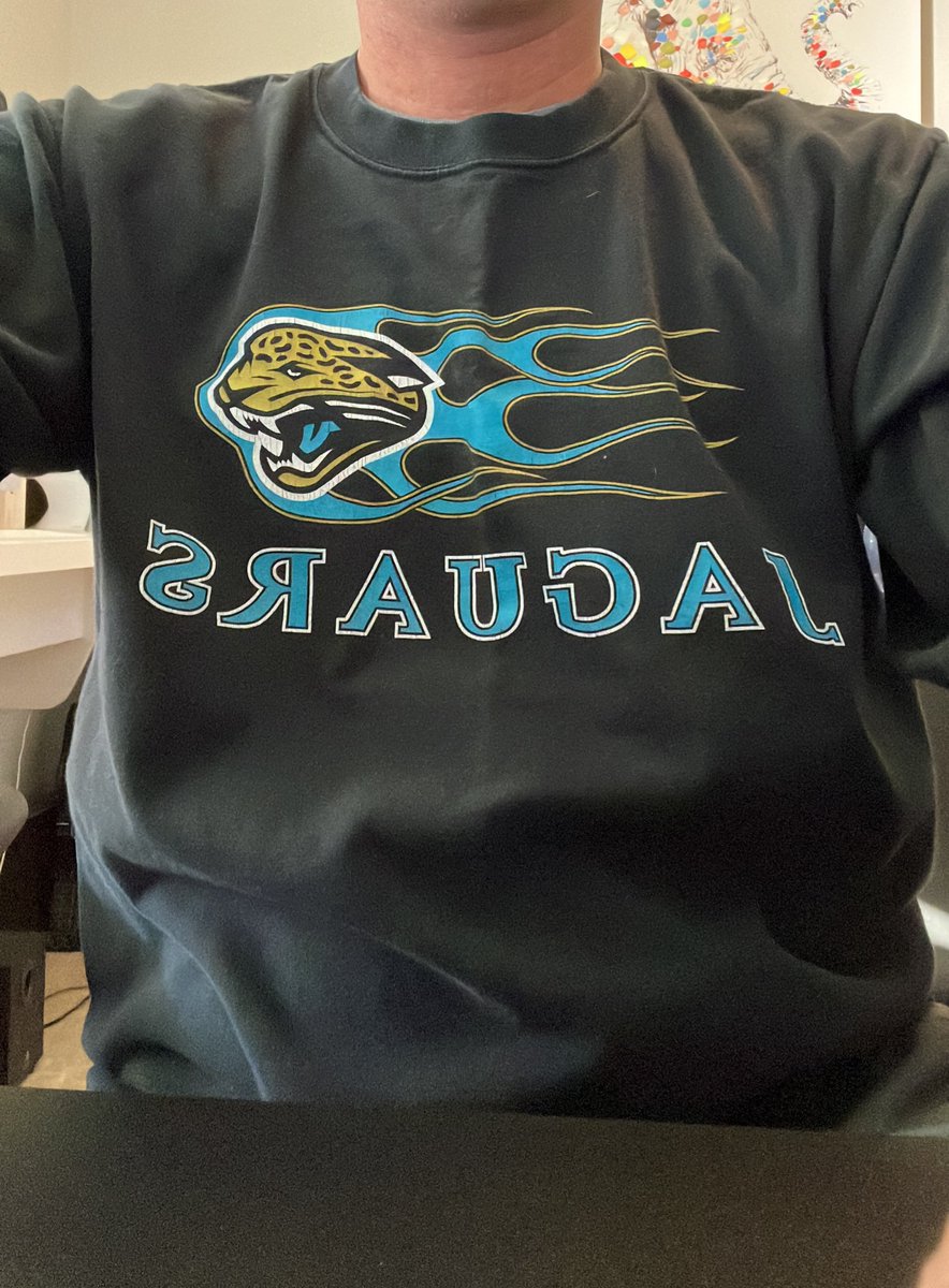 JMHessDesign's tweet photo. Omg, just found my @Jaguars shirt from 99-2000 buried in my closet. The flame sleeve treatment never gets old. #Duuuval #AFCSouth #Section205 https://t.co/bOwNVAHow2