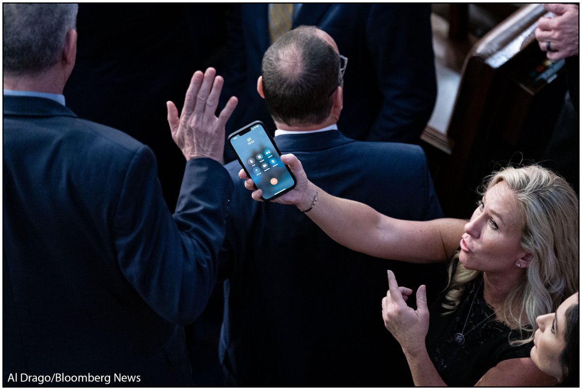 Rep. Marjorie Taylor Greene, a Republican from Georgia, holds her smart phone with former US President Donald Trump on the line, as Rep. Matt Rosendale, a Republican from Montana, waves it off during a meeting of the 118th Congress in the House Chamber on Friday.

#SpeakerVote
