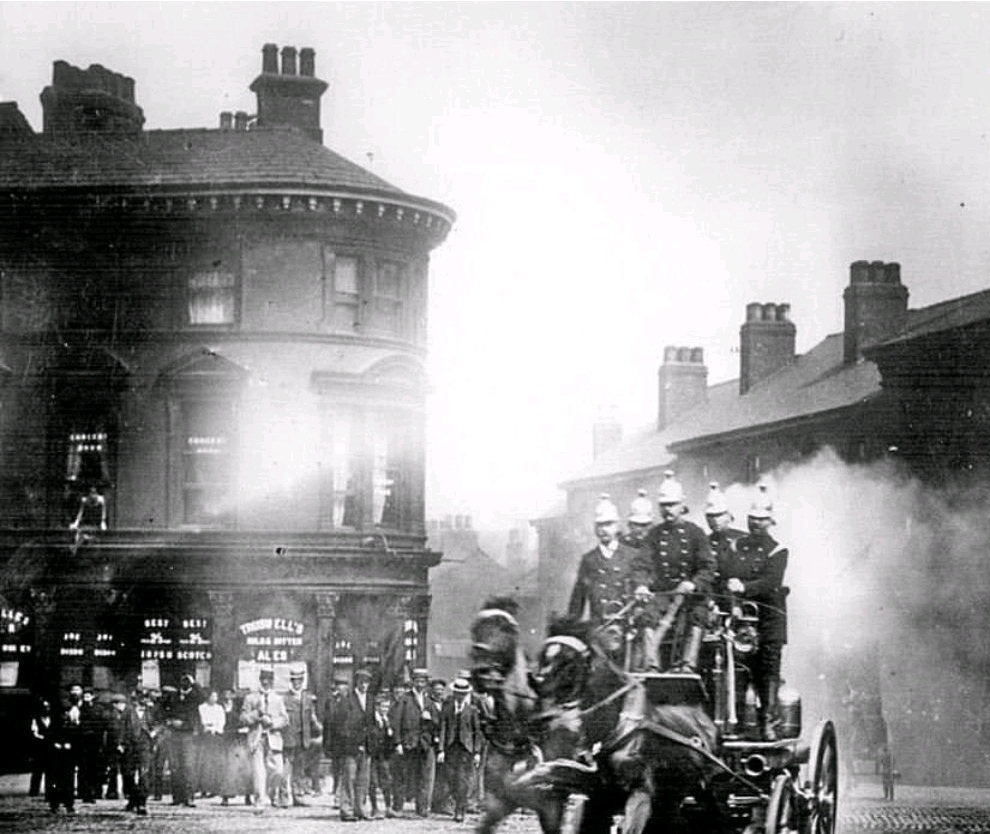 A fire engine coming round the corner of West Bar and Corporation Street in Sheffield, the George and the Dragon pub stands in the background. C1901