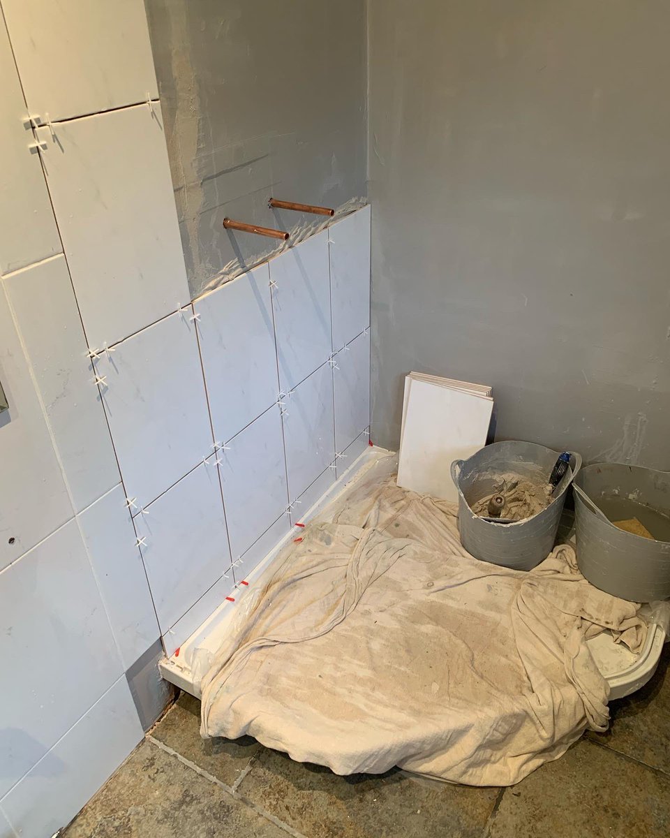 The transition from old to new tiles will be hidden behind shower screen profiles, we ran a grinder up the tiles … tiles are smaller than existing so we’ve followed the tile height from picture rail tile (grout lines don’t match up) #showers #tiling #plumbing #showertray