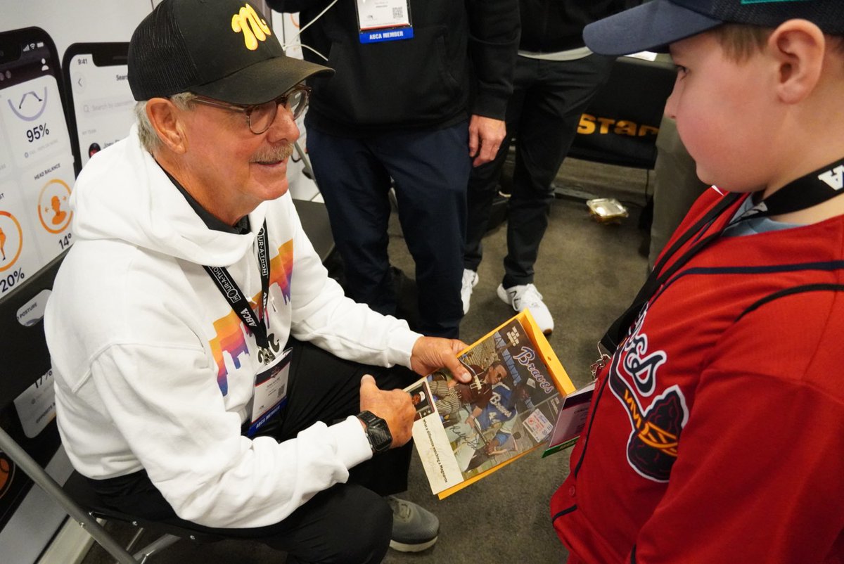 TeamMSTRD's tweet image. .@tomhouse signing a vintage 1974 @Braves scorebook for this young fan. ✍️⚾️ #ABCA2023