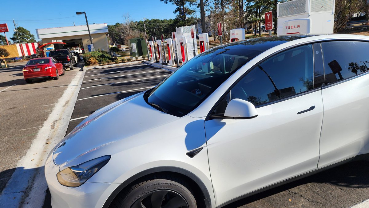 chernly97's tweet photo. Kind of a weird setup here in Pooler Georgia. There's a car wash line in front of the Tesla chargers. At one time some cars were blocked in by the line of people trying to get in the car wash. Other than that all chargers seem to be working. @RateYourCharge https://t.co/mvSph1EiF2