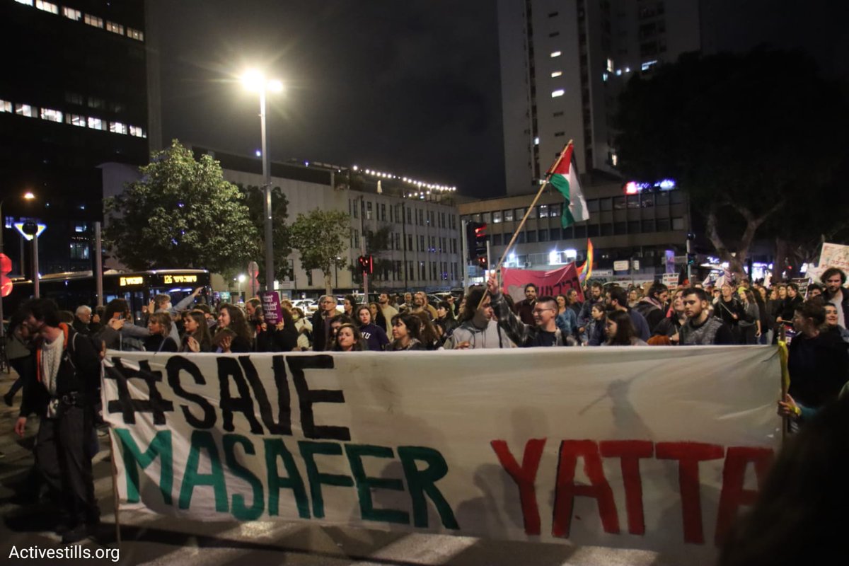 activestills's tweet photo. NOW: Israeli anti-Zionist activists hold banners and Palestinian flags to condemn Israeli colonialism and to interrupt a mass protest against the new far-right government in Tel Aviv, which is mainly composed of Zionist left protesters. Photos: Activestills (1/2). https://t.co/YGJx1iRYdn