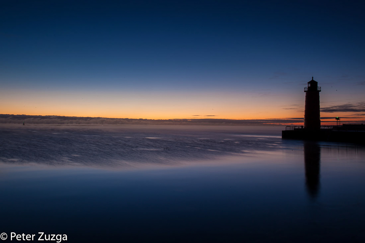 Jan. 7, 2022. The cold breaking of dawn above Lake Michigan beyond the Pierhead Light in Lake Shore State Park in Milwaukee, Wisconsin.