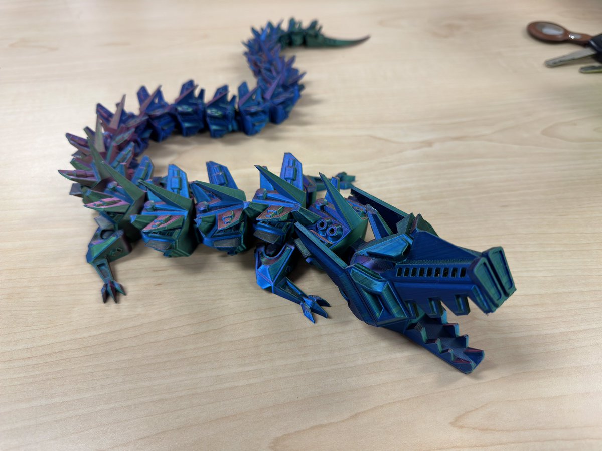 joshmyers84's tweet photo. A 3D printed robot dragon I did in a tri-colored silk filament on the Bambu labs x1 Carbon. 🔥 #3Dprinting #3DbyJosh #Josh3D https://t.co/134yCa8pt0