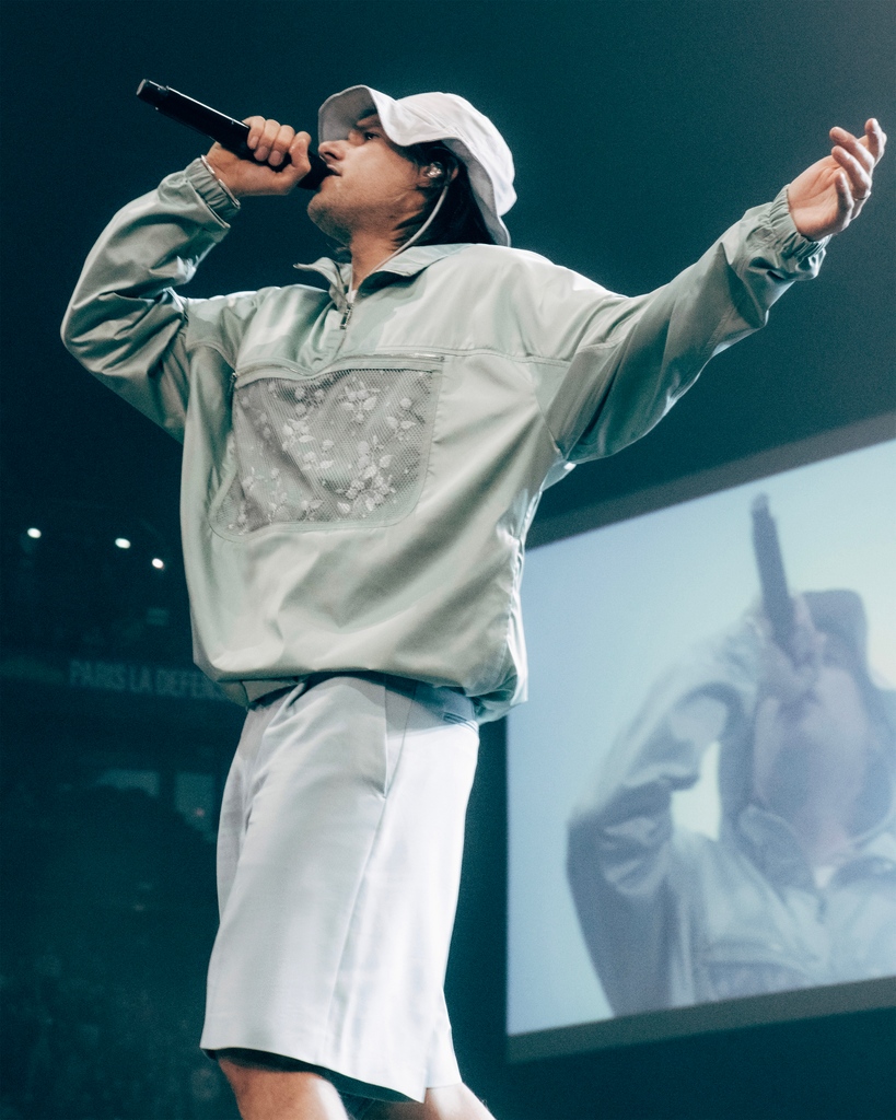 Dior's tweet photo. In a selection of custom looks by Kim Jones, @Orel_San took over the Paris La Défense Arena garnering attention from fans for his musical talent and exceptional wardrobe. To get a look at the work that went into performance, find the full video soon on our YouTube channel. https://t.co/Gb6yWyL2sP
