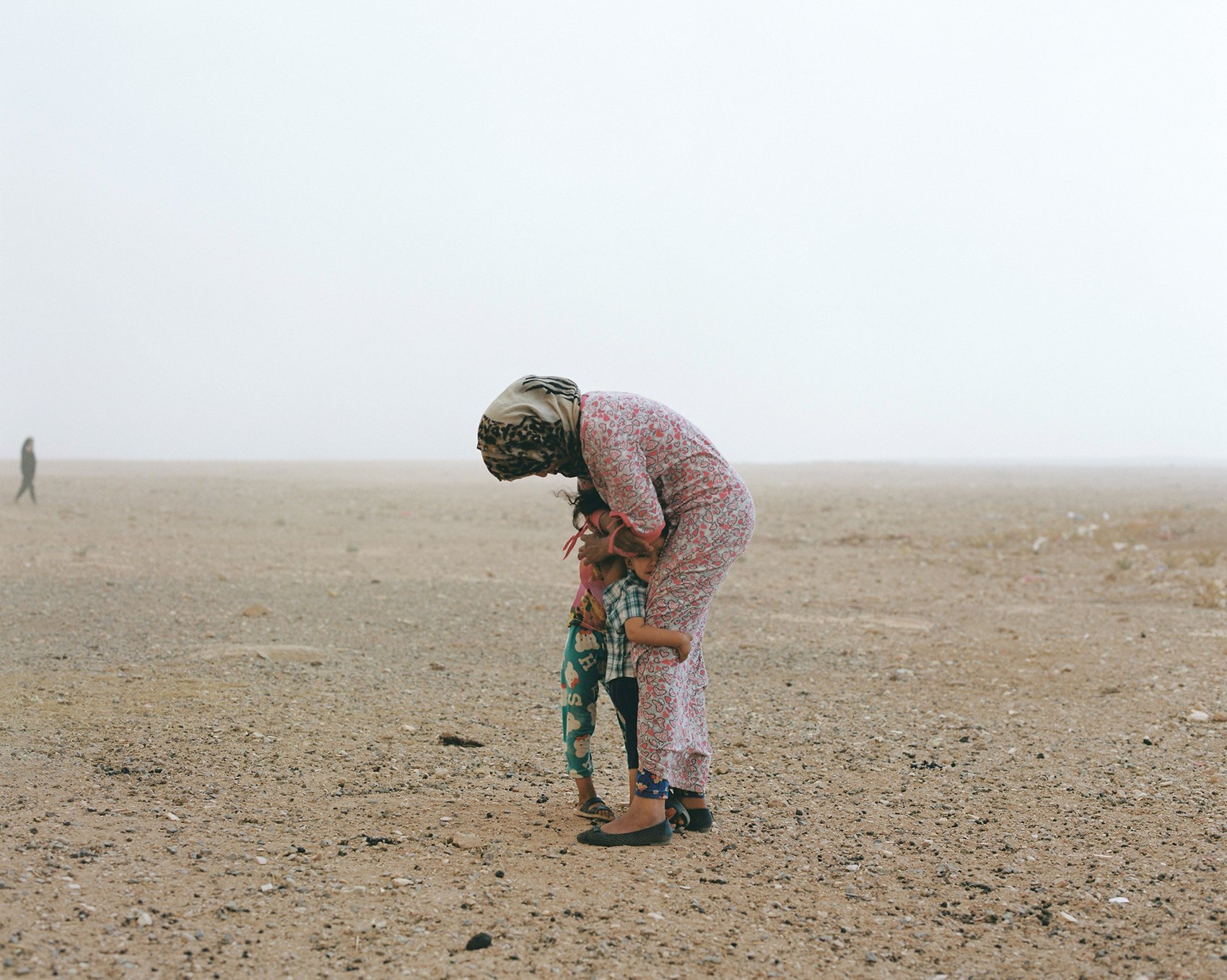 
Sincerely. Tendrara, Morocco.
Yamina Kotit shields her children from the strong winds which are sweeping the area, causing desertification and impacting her family's nomadic way of life. (September 2021) Photo by Yzza Slaoui for @Pics4Humanity