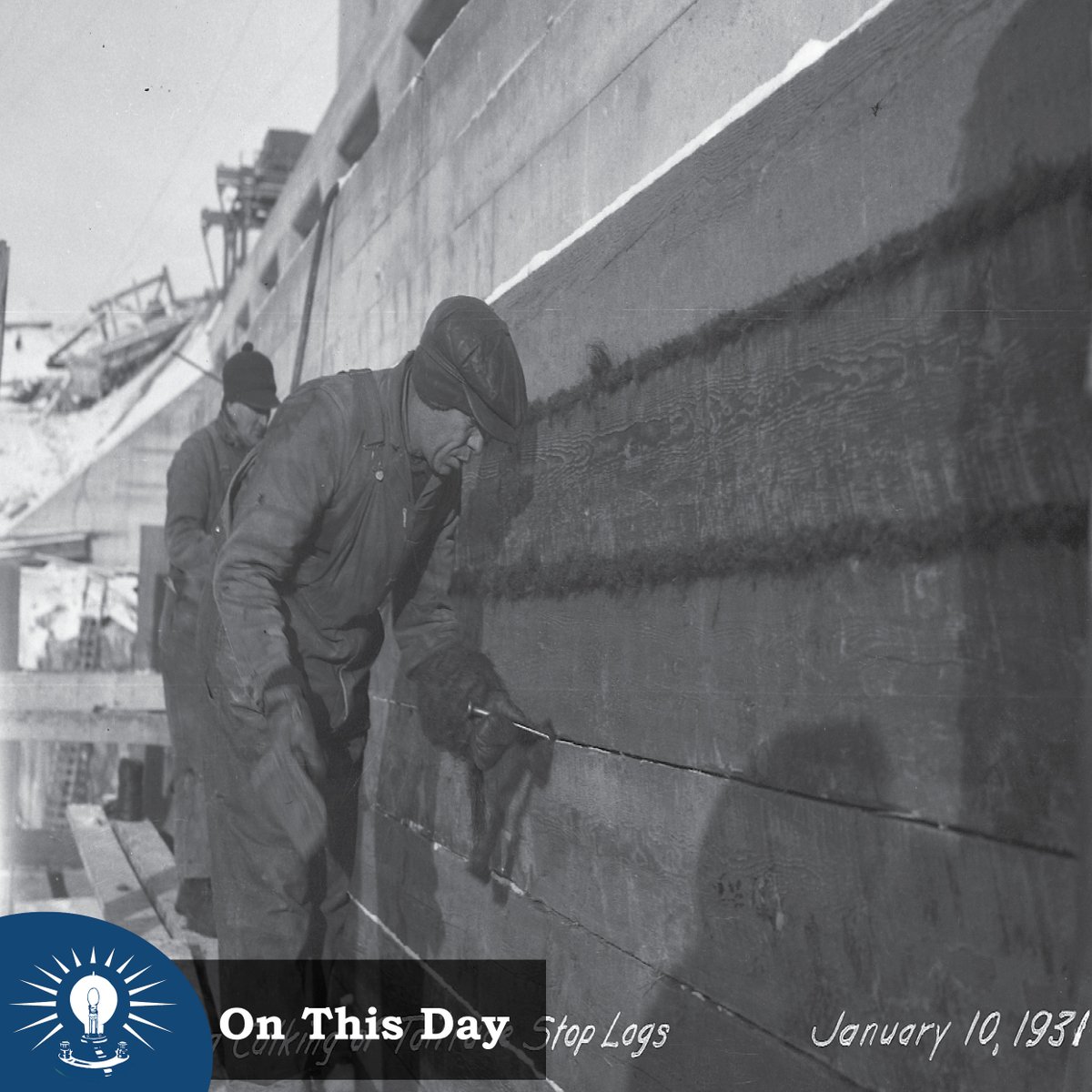 View of men caulking the tailrace stop logs at the #SevenSisters dam #OnThisDay, Jan 10 in 1931. A tailrace is a water channel below a generating station that carries water (tailwater) away from the generating station. A Stop log is a structure used to control the flow of water.
