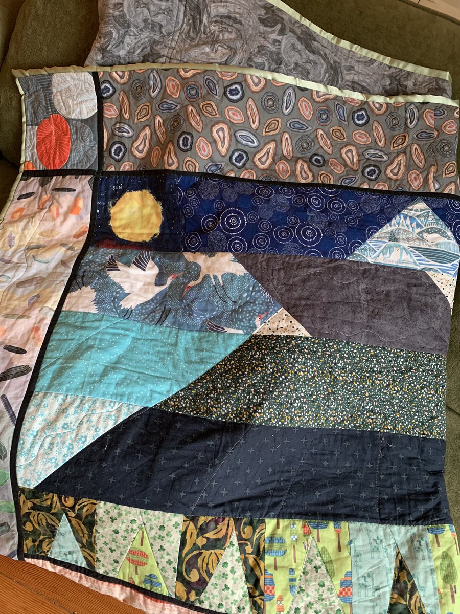 Paleowin's tweet photo. It’s done and gifted now! Geologic cross section quilt. Based on a sketch by my partner, designed, pieced, and quilted by me! Pluton and active magma chambers following a fault resulting in an erupting cinder cone in front of a larger dormant volcano. https://t.co/5tP6e3SMyr