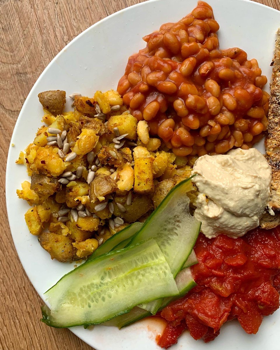 Brunch of the day. #dEATS:

- ‘Cubed’ potatoes sautéed in oil with seasonings and dash of baking powder to crisp. Includes cannellini beans + sunflower seeds
- Tinned tomatoes cooked in saucepan and reduced
- Leftover cucumber cut with cheese slice
- Hummus
- Toast
- Baked beans