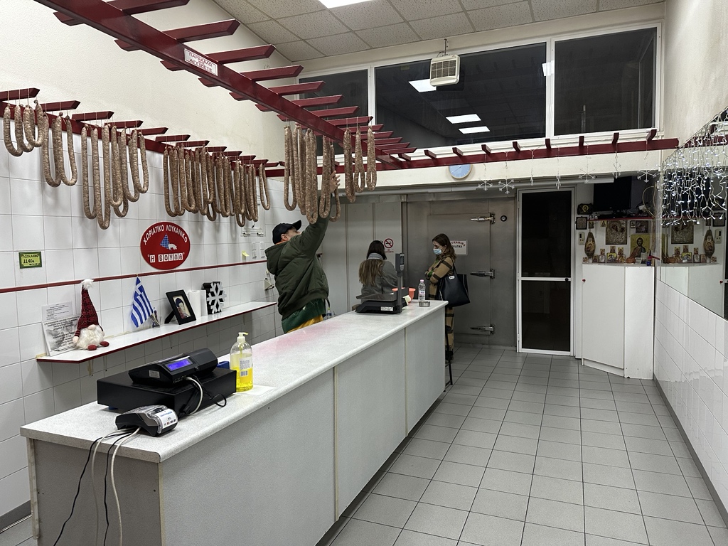 My favorite shop in Lamia is Βούλα. A mostly empty space with the purpose of selling a single item: Greek sausage (plain and spicy variants). It's probably thr best Greek sausage in the world. 

(Note the Christmas decorations and the Christian Othodox icons in the right corner).