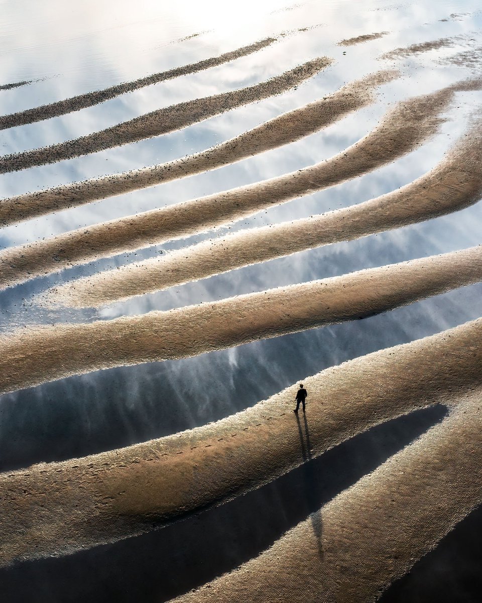 MadsPeterIverse's tweet photo. One of my top favorite photos of 2022! I love the scale, abstraction, and that you can see the reflection of the clouds in the still water 🤩 https://t.co/kUaGE6xiOR