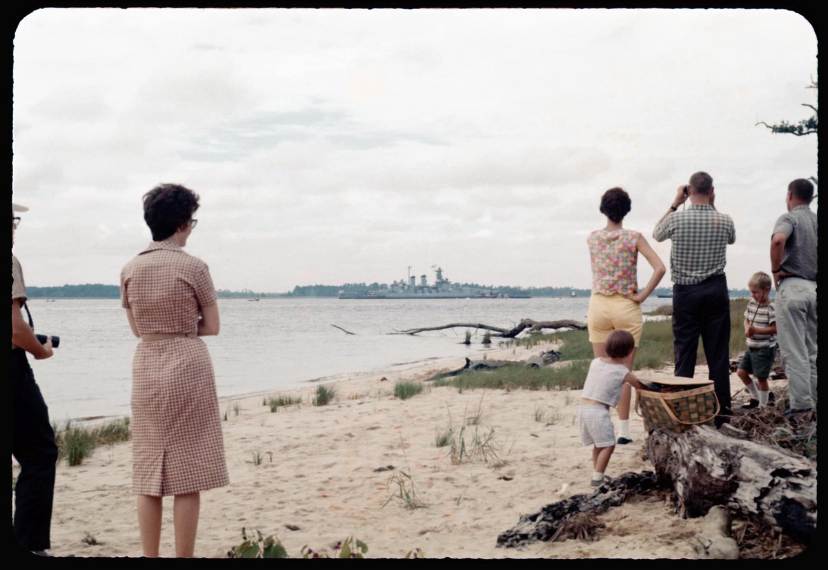 NCmuseumhistory's tweet photo. Onlookers watch the USS North Carolina arrive at its new permanent home in Wilmington, NC on Oct. 2, 1961. 🚢 This image is featured in our photography exhibit, "Are We There Yet? North Carolina's Variety Vacationland” which is CLOSING on Monday, January 2. See it before it goes! https://t.co/EFxpm9K6tL