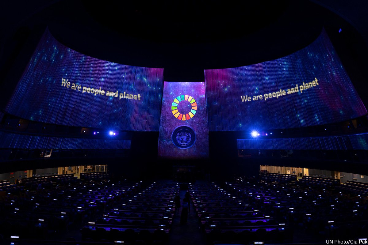 UN's tweet photo. #YearInReview: The promise of the #GlobalGoals illuminated #UNGA hall during this year's SDG Moment with world leaders & more.
The special event highlighted the importance of global action for a better future for all. https://t.co/Ss4uMcXdcV https://t.co/oK25dMYgXP