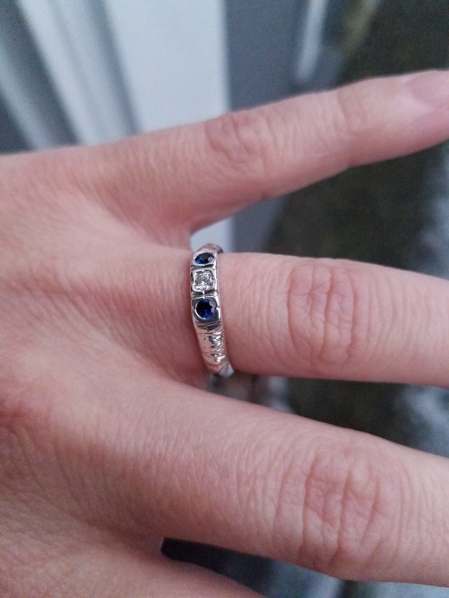 My long-time boyfriend, best friend, &amp; partner, <a href="/Treedgems/">Treedgems Silver</a> made me this engagement ring! We were up the Space Needle in Seattle after seeing <a href="/thesmiletheband/">The Smile</a> when he asked. It's hand-fabricated, sterling silver, two sapphires framing a diamond, cradled in hand engraved mountains.