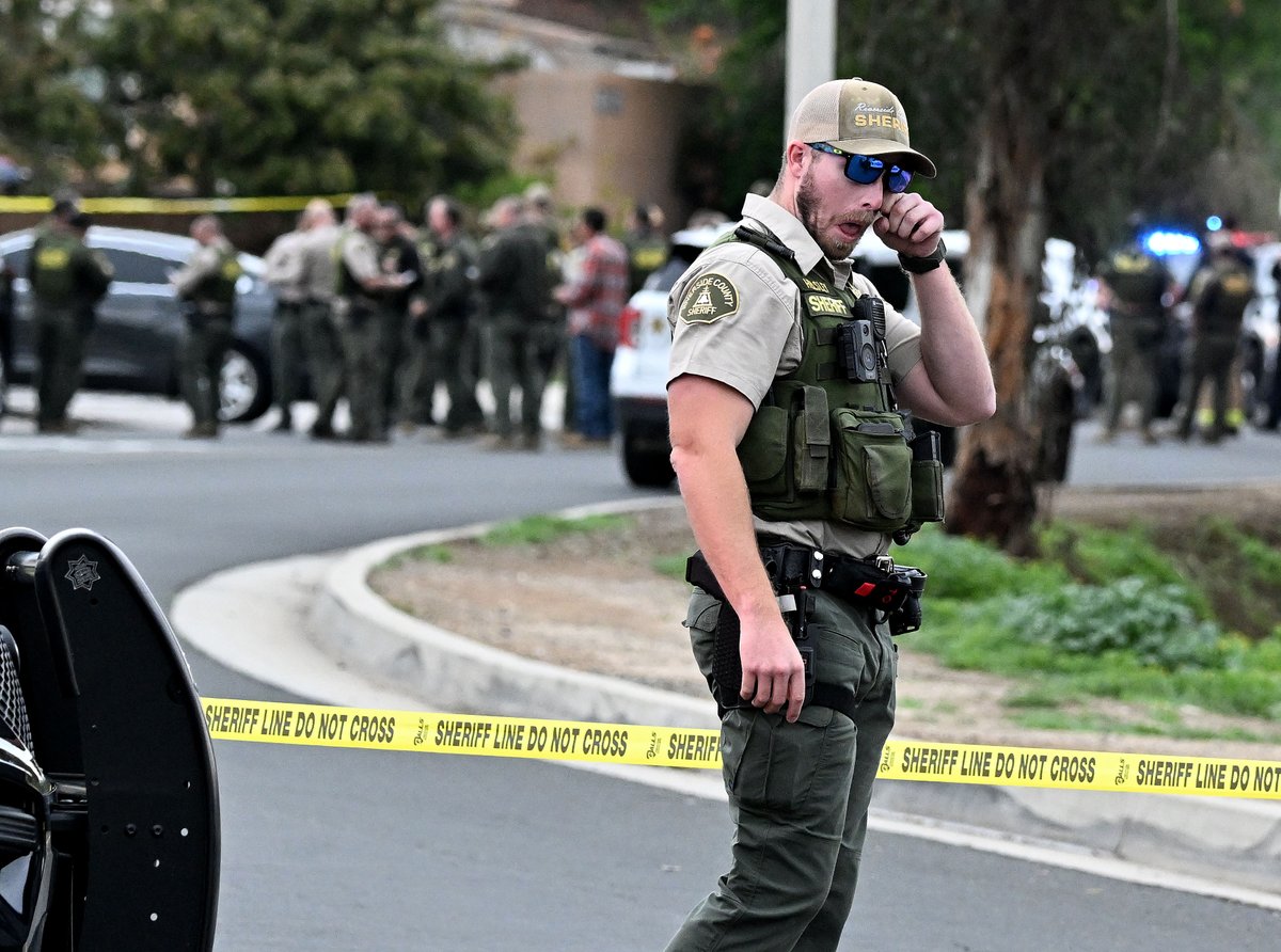 WillLesterPhoto's tweet photo. A Riverside County Sheriff deputy wipes his eye after hearing of the fatal shooting of a fellow deputy in Jurupa Valley Thursday afternoon. The suspect is still at large. https://t.co/aRM3P55pok