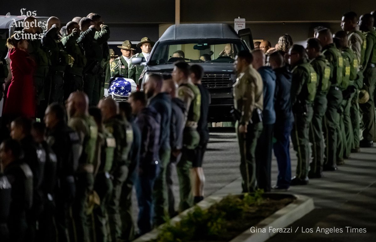GinaFerazzi's tweet photo. Law enforcement stand at attention and salute as the Honor Guard carries the flag draped casket of Riverside County Deputy Isiah Cordero who was killed during a traffic stop in Jurupa Valley where he was a motor officer @RSO https://t.co/P32YbPsLaI