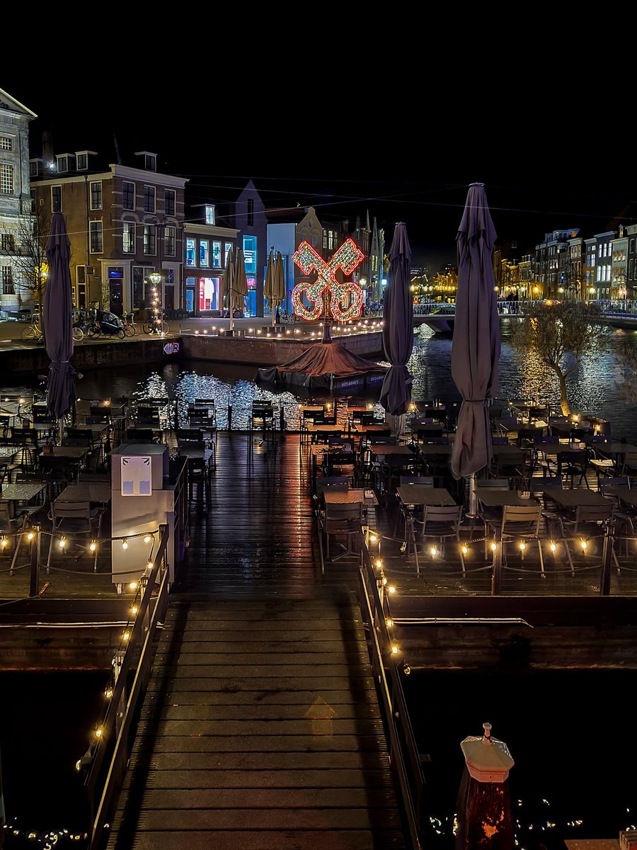 Leiden at night with Christmas and New year decorations #Netherlands #bestofnetherlands #stadvanontdekkingen #streetphotography #reflection #bridge #wag #canals #waterway #mobilephotography #travel #restaurant #lights #symbol #walk