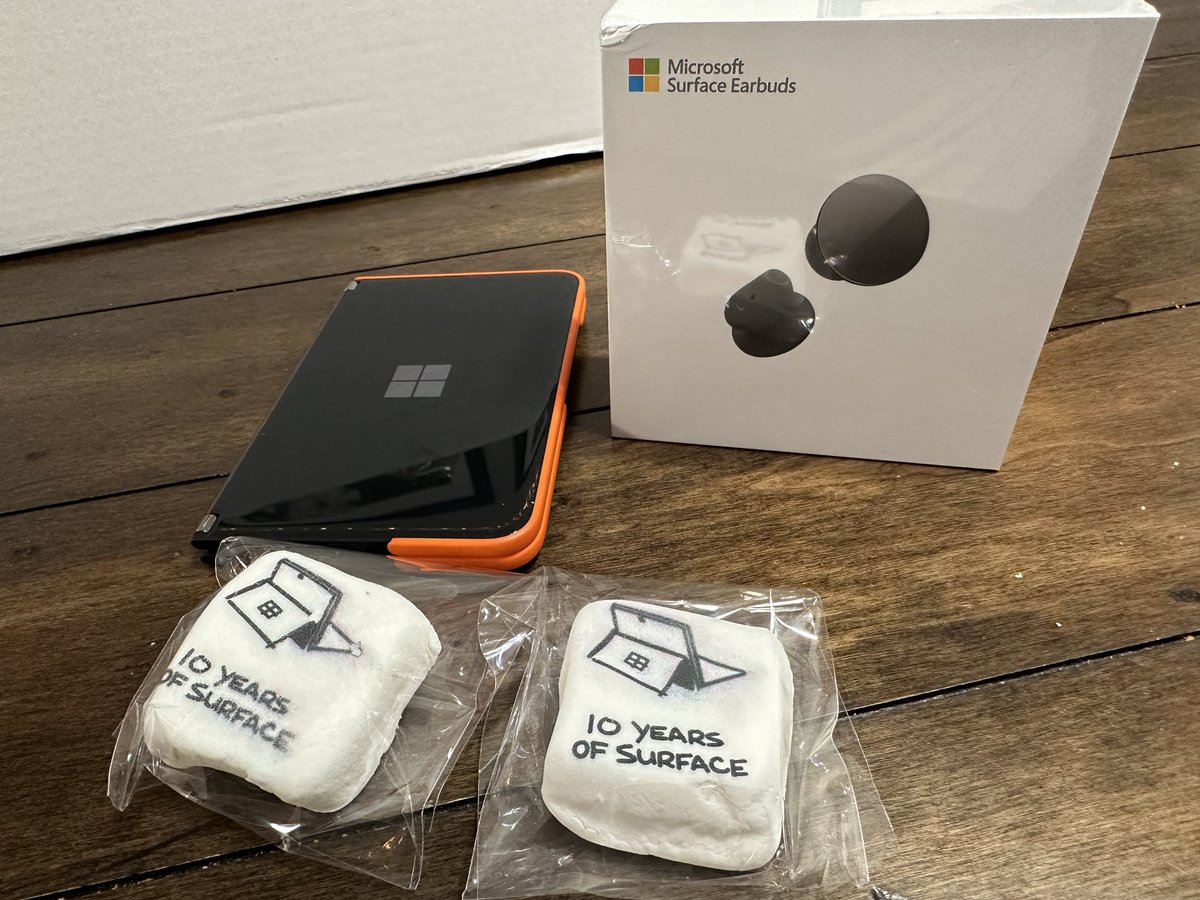 AdamJMatlock's tweet photo. A super cool Christmas gift from the fine folks over at @surface! Very cool. I always wanted to try out the Surface Buds! Also, I really love this quilt! Thank you. #10YearsOfSurface #Surface #Microsoft https://t.co/XjFrY1mPa0