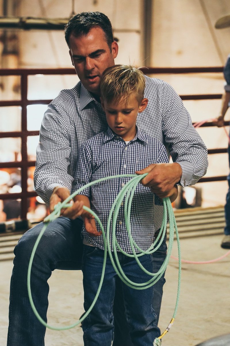 GovStitt's tweet photo. Finally, my staff's favorite picture from 2022 (and I agree)!

I get to do a lot of cool things as governor, but nothing is more special than being a father and having than moments like this - teaching my youngest son Houston to rope. https://t.co/g8ykuxerrB