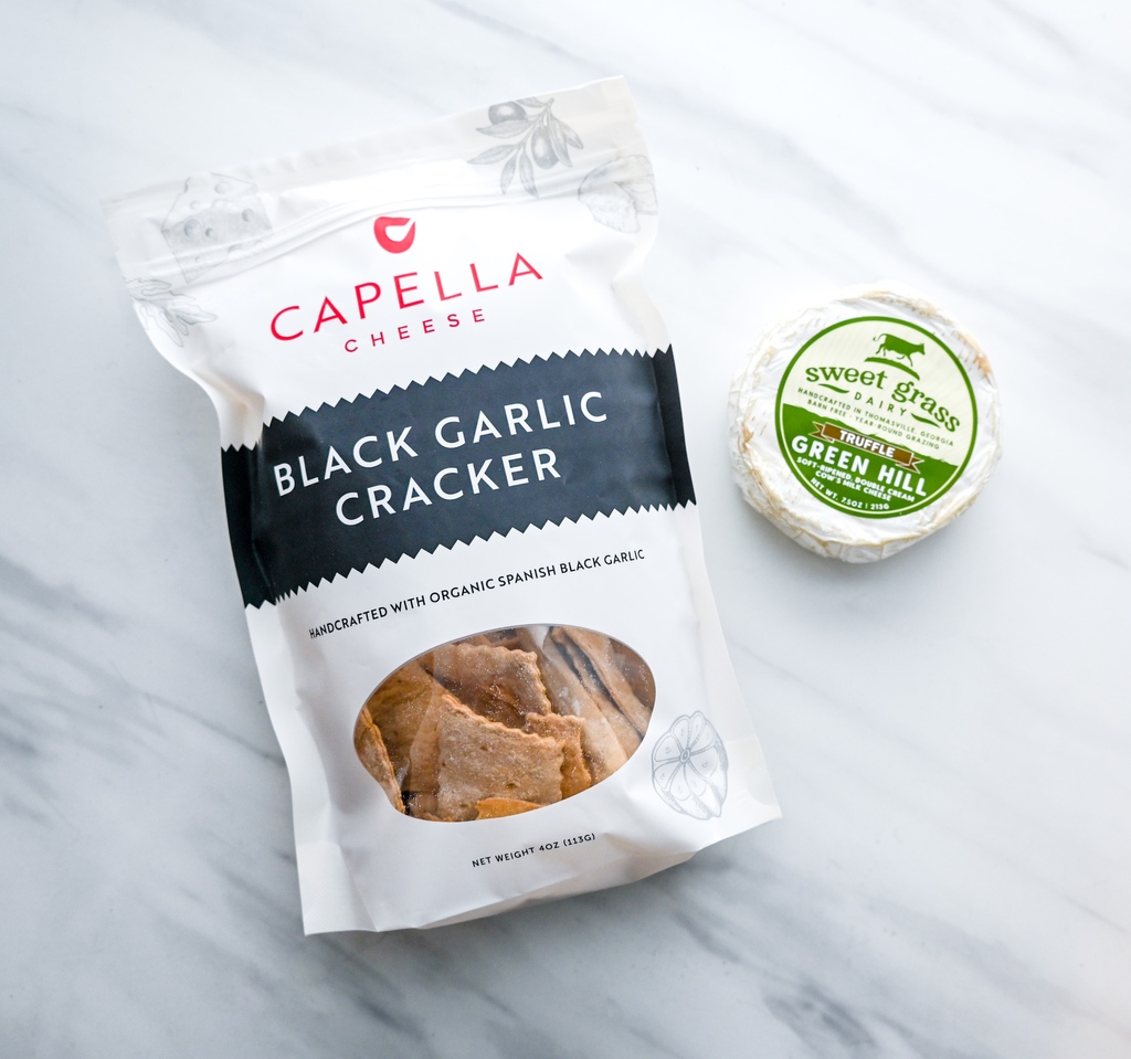 Sweet Grass Dairy's Truffle Green Hill and our Black Garlic Crackers are a deliciously flavorful combo that pair perfectly with a glass of bubbly! 🥂