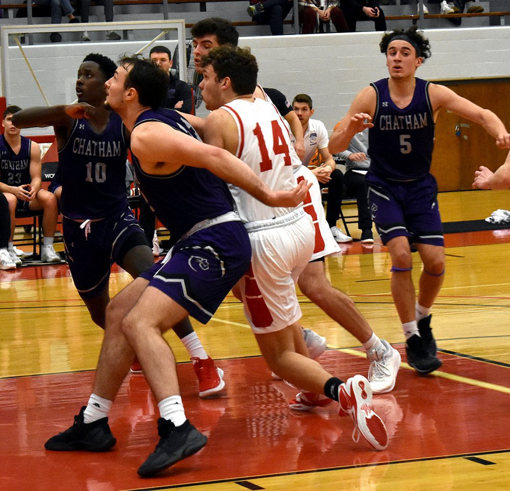 Sharpsville grad James Thomas battles with Greenville grad Ben Cano for a rebound Saturday during the Grove City-Chatham men's basketball game. At right is Grove City H.S. grad Marcos Cintron (5).
📷 John Hake