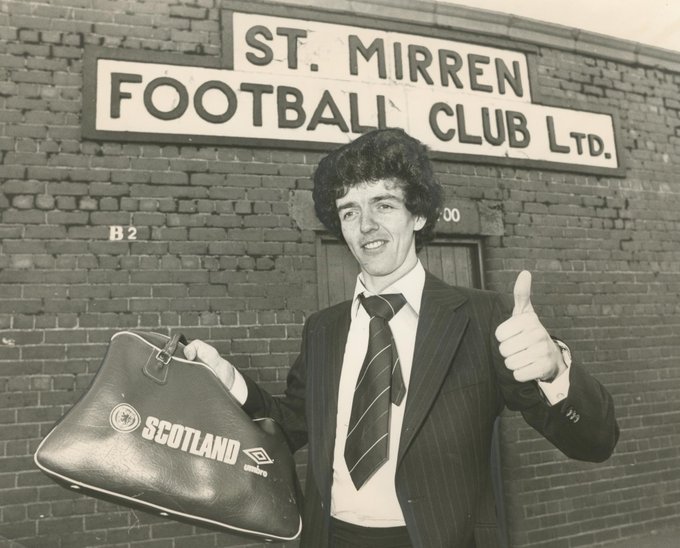 A young Frank McGarvey stands outside the turnstiles at St. Mirren's Love Street Stadium in Paisley. He holds a Scotland training bag in his right hand and gives the cameras a smile and a thumbs-up with his left hand after being called up to Scotland's youth ranks.  This image is property of Memories Scotland and should not be used or reproduced without prior written permission.
