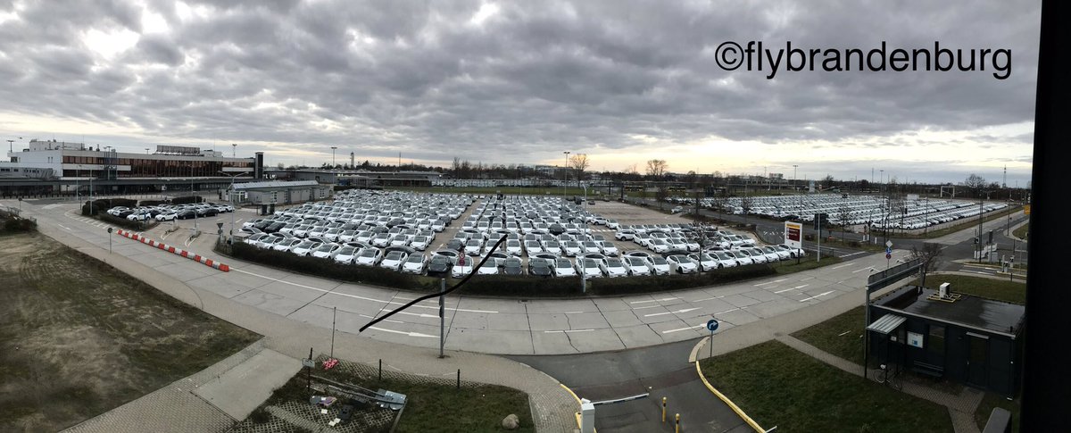 flybrandenburg's tweet photo. In case you're wondering where all the cars from #GigaBerlin went, they were parked in huge parking lots in front of a disused terminal at Berlin Airport. I estimate that 1500-2000 cars are parked here. https://t.co/cmrIhkYvfC