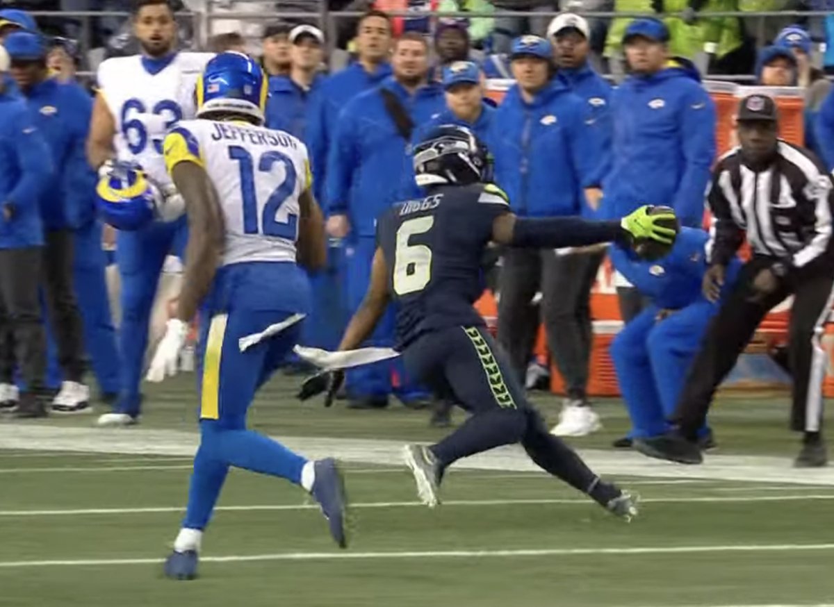 SBNation's tweet photo. Quandre Diggs pointed directly at former Seahawk Bobby Wagner while picking off a Rams pass to set up the Seattle win in OT 

Diggs' interception also led to Detroit, his former team, being eliminated from the playoffs 👀 https://t.co/SPuTaSy4O7