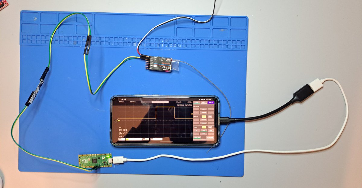 aebejcek's tweet photo. For clarity, here's a pic of the whole setup. My last Android phone, a USB OTG cable, a $4 RPi Pico, and a 10:1 voltage divider between the Pico and the measured signal for safety. I used my Chips on a Stick board to make the voltage divider. https://t.co/vSSXFh4mHA