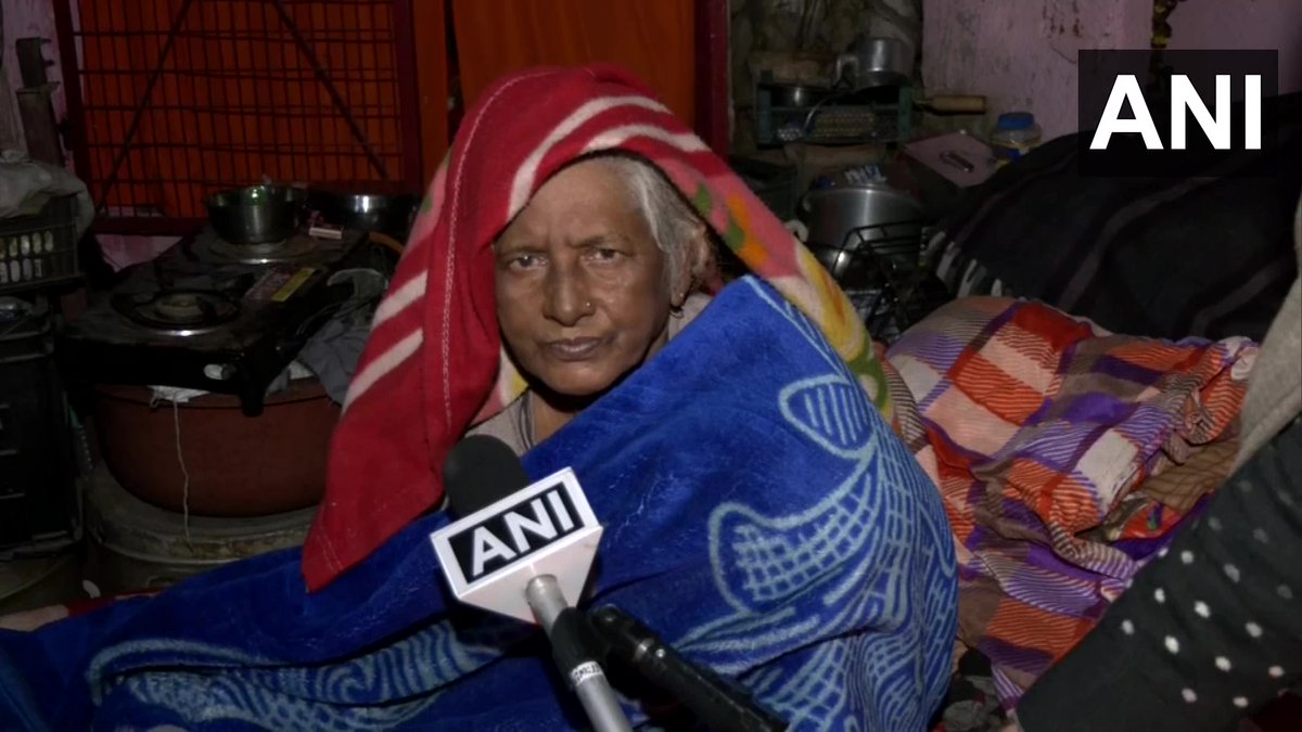 ANI's tweet photo. Delhi | Dogs &amp; their octogenarian caretaker thrown out of their home by MCD

MCD workers demolished my jhuggi &amp; shop, took away my belongings &amp; also beat my dogs. I have at least 250-300 dogs. I am sitting under the tree now with my dogs: Pratima Devi, caretaker of dogs https://t.co/gzw1CebUAr