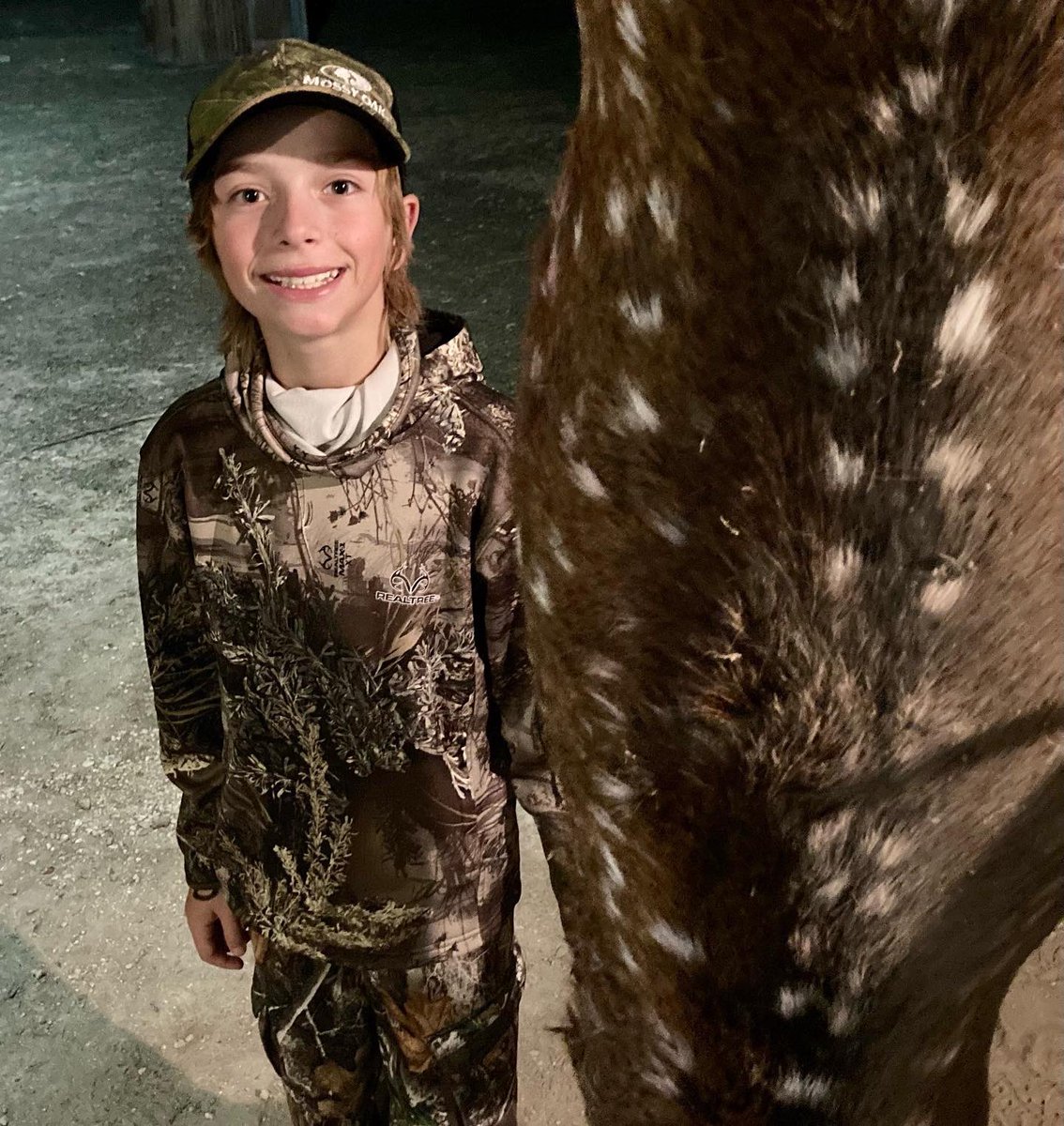 RMourning's tweet photo. Proud of my guy. Stuck it out this afternoon and got his first axis just before sunset. He’s pumped!! Meat in the freezer. @Becca_Mourning @SavageArms @MossyOak #backyardhunts #AxisSzn https://t.co/yPdnFtcGTg