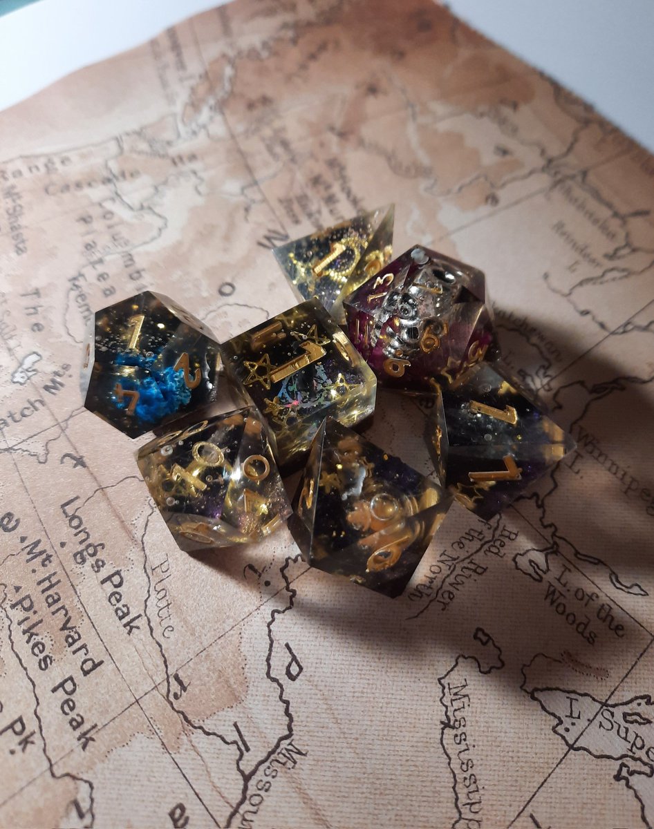 Deadderson's tweet photo. Whoops I've been busy over the holiday and run ragged, but here's the last set of dice of 2022. Here's to hoping for more and better dice in the new year! @OdmWrites @WMadien @smartcookie727 #handmadedice #dnd #ttrpg #dnd5e https://t.co/nZKS0T5ewF